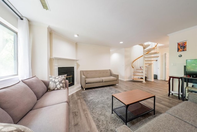 19 Burnham St Unit C2, Belmont, MA 02478 - living room featuring stairway, crown molding, wood finished floors, a glass covered fireplace, and recessed lighting