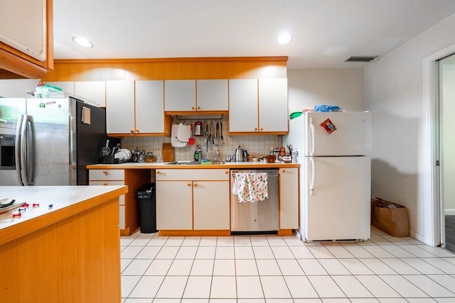 19 Burnham St Unit C2, Belmont, MA 02478 - kitchen with appliances with stainless steel finishes, tasteful backsplash, light countertops, recessed lighting, and white cabinetry