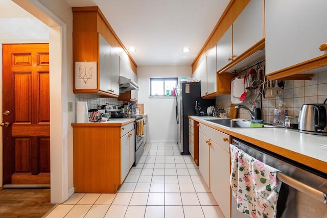 19 Burnham St Unit C2, Belmont, MA 02478 - kitchen with stainless steel appliances, light countertops, decorative backsplash, recessed lighting, and baseboards