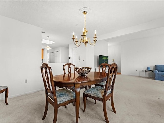 dining room featuring light carpet, a notable chandelier, and baseboards