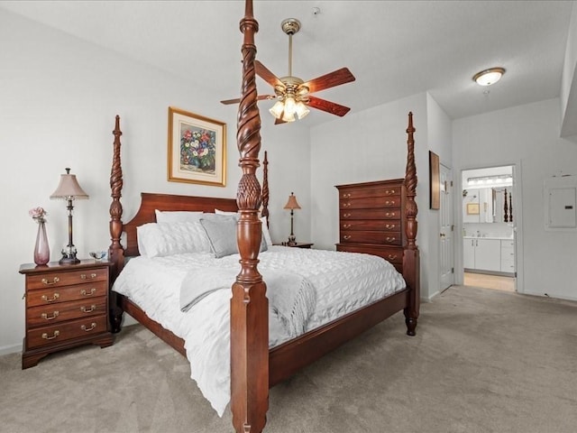 carpeted bedroom featuring electric panel, ensuite bath, and ceiling fan