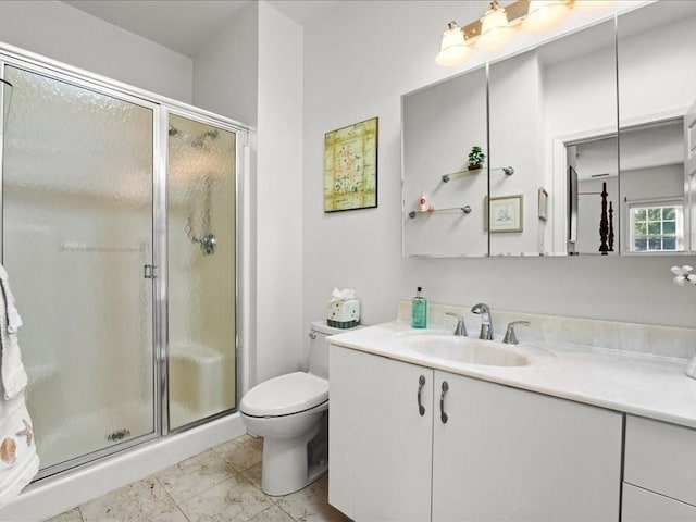 bathroom featuring toilet, a stall shower, and vanity