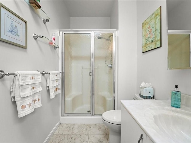 full bathroom featuring baseboards, vanity, toilet, and a shower stall