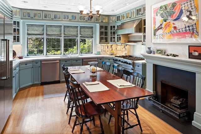 dining area featuring a chandelier, light hardwood / wood-style flooring, and sink