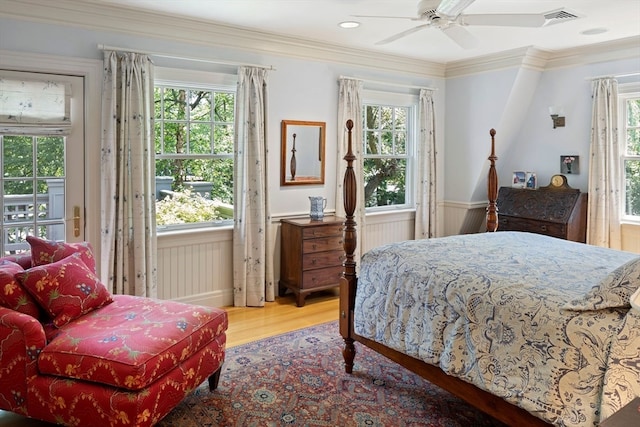 bedroom with multiple windows and hardwood / wood-style flooring