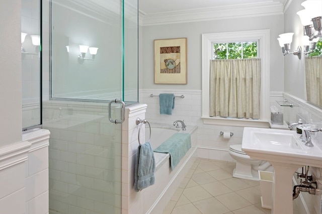 full bathroom featuring plus walk in shower, crown molding, tile patterned floors, toilet, and tile walls