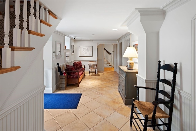 foyer entrance featuring crown molding and light tile patterned flooring