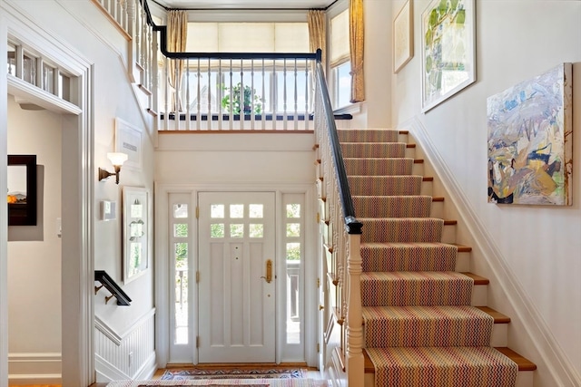 foyer with hardwood / wood-style floors and a high ceiling