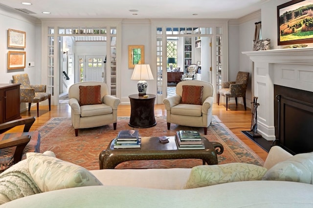 living room with crown molding and hardwood / wood-style flooring