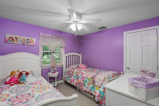 14 W Winkley St, Amesbury, MA 01913 - carpeted bedroom featuring a baseboard radiator, a textured ceiling, and ceiling fan
