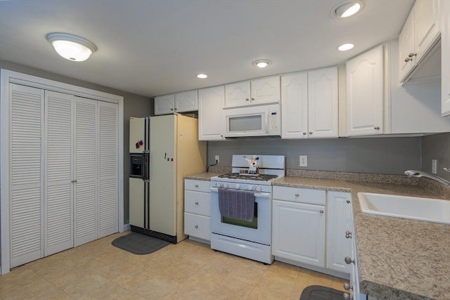 14 W Winkley St, Amesbury, MA 01913 - kitchen featuring white appliances, white cabinetry, recessed lighting, and light countertops