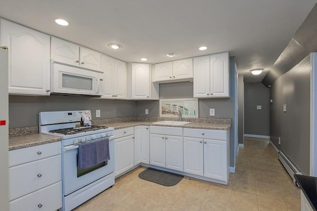 14 W Winkley St, Amesbury, MA 01913 - kitchen featuring white appliances, a baseboard radiator, white cabinets, recessed lighting, and light countertops