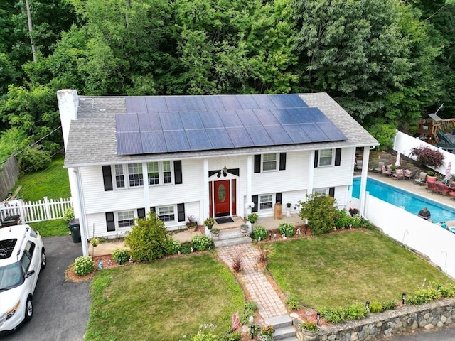 14 W Winkley St, Amesbury, MA 01913 - split foyer home with solar panels, a fenced backyard, and roof with shingles