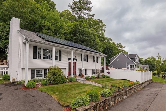 14 W Winkley St, Amesbury, MA 01913 - raised ranch featuring a chimney and roof mounted solar panels
