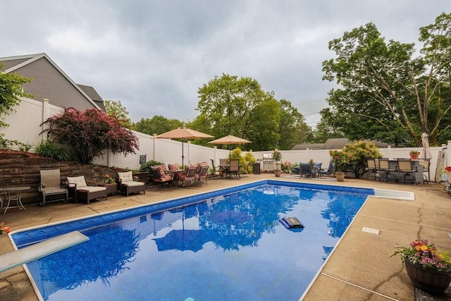 14 W Winkley St, Amesbury, MA 01913 - view of pool featuring outdoor dining area, a patio, a fenced backyard, and a diving board