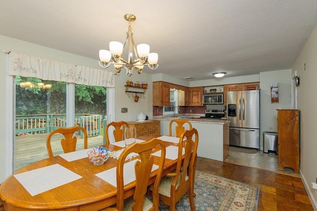 14 W Winkley St, Amesbury, MA 01913 - dining space with a chandelier and a textured ceiling