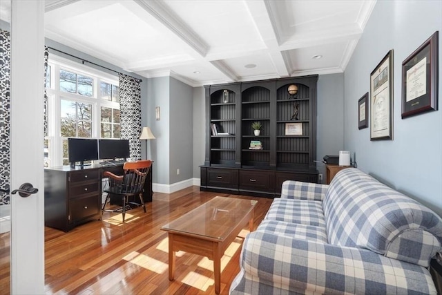 living area with coffered ceiling, wood finished floors, baseboards, ornamental molding, and beam ceiling