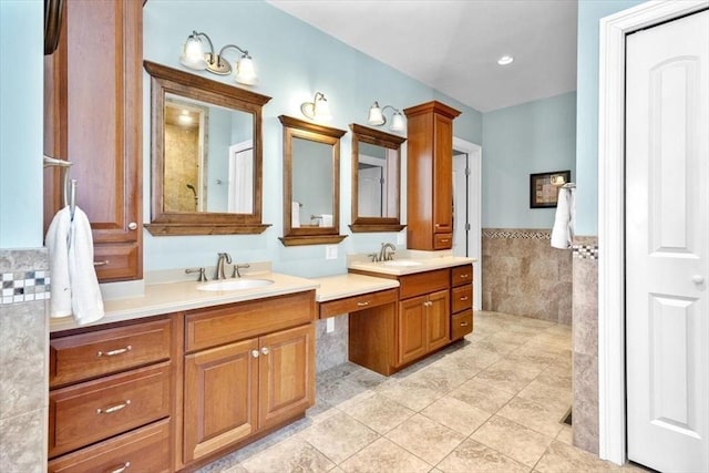 full bathroom featuring a wainscoted wall, tile patterned flooring, tile walls, and vanity