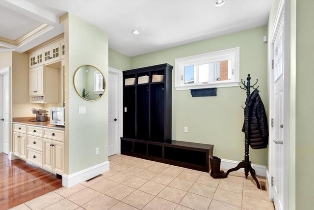 entrance foyer featuring light tile patterned floors, baseboards, and recessed lighting