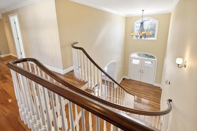 entrance foyer featuring ornamental molding, plenty of natural light, and wood finished floors