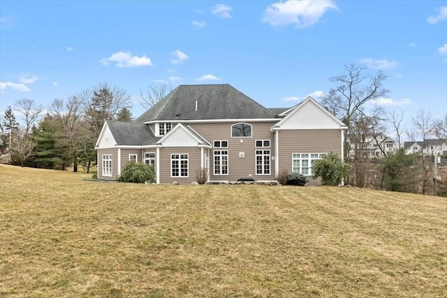 rear view of house with a yard