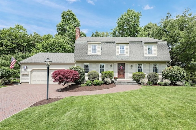72 Ryder Cir, North Attleboro, MA 02760 - view of front facade featuring an attached garage, a chimney, a shingled roof, a front yard, and decorative driveway