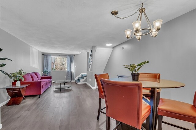 dining room featuring a chandelier and wood-type flooring