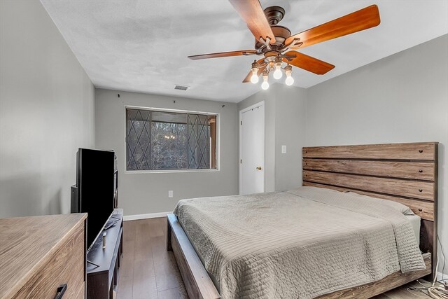 bedroom featuring ceiling fan and dark hardwood / wood-style flooring