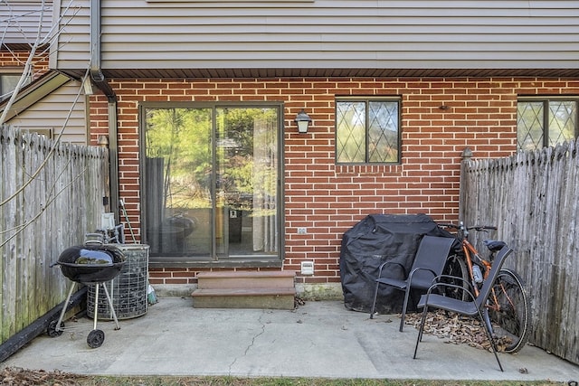 doorway to property featuring central AC unit and a patio area