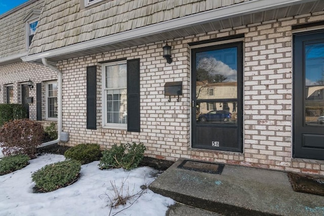 view of snow covered property entrance