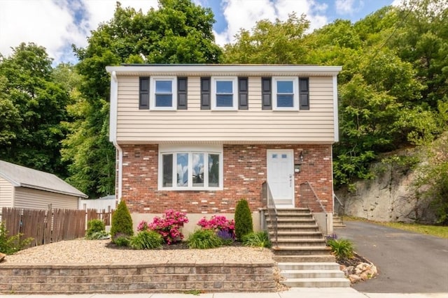 56 Cliff St, Malden, MA 02148 - colonial inspired home featuring entry steps, brick siding, and asphalt driveway