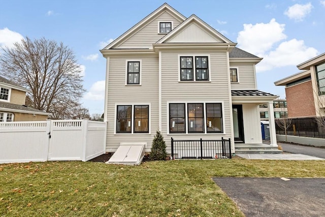 rear view of house featuring a yard