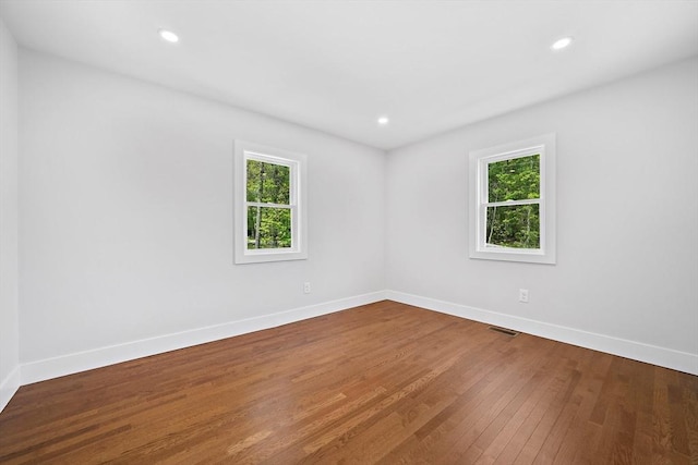 spare room with wood-type flooring