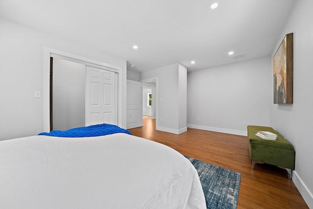 bedroom with a closet and hardwood / wood-style flooring