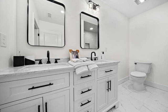 bathroom with toilet and vanity