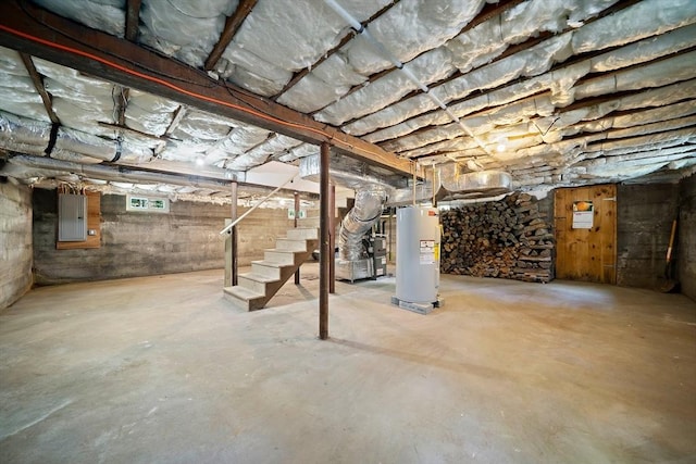 basement featuring electric panel and water heater