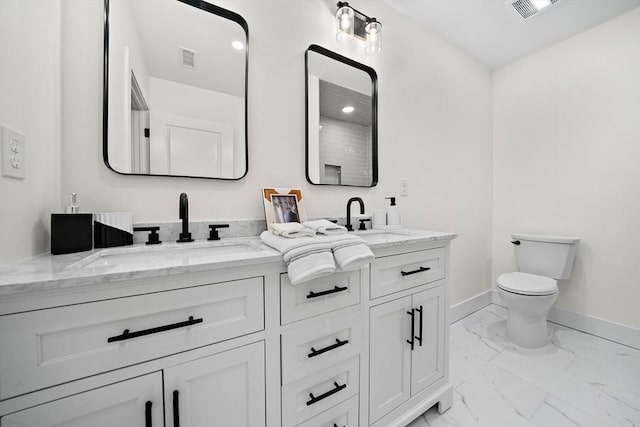 bathroom featuring toilet and vanity