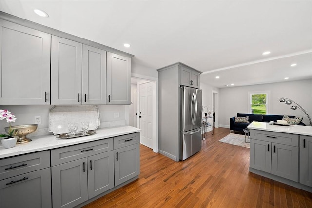 kitchen featuring light wood-type flooring, gray cabinetry, and stainless steel refrigerator