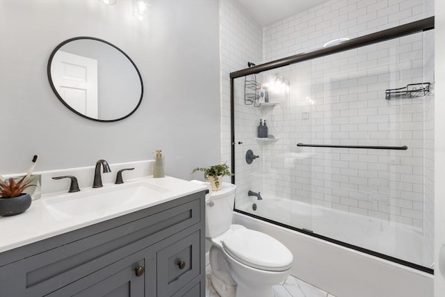 full bath with toilet, combined bath / shower with glass door, and vanity