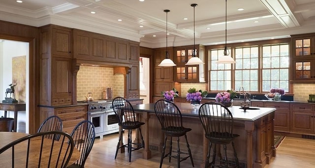 495 Hugh Cargill Rd, Concord, MA 01742 - kitchen featuring a kitchen island, dark countertops, double oven range, and brown cabinetry
