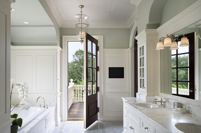 495 Hugh Cargill Rd, Concord, MA 01742 - bathroom with crown molding, a sink, a garden tub, and double vanity