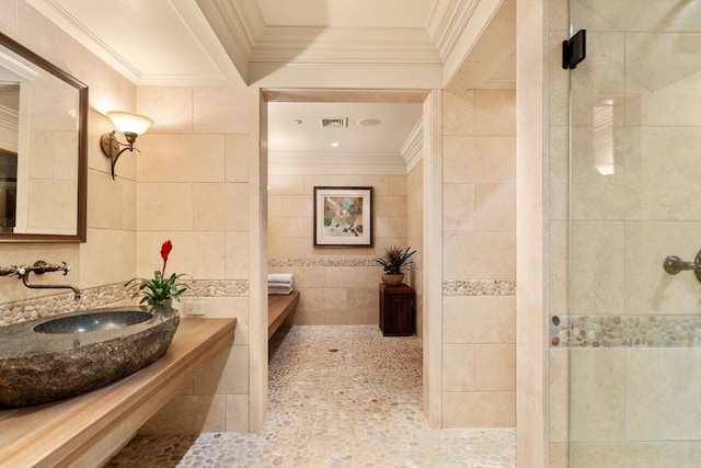 495 Hugh Cargill Rd, Concord, MA 01742 - bathroom with crown molding, a sink, tile walls, visible vents, and a stall shower