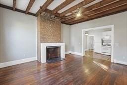 unfurnished living room featuring dark hardwood / wood-style floors and beam ceiling