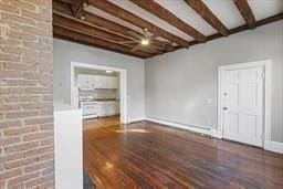 unfurnished living room with beam ceiling and hardwood / wood-style flooring