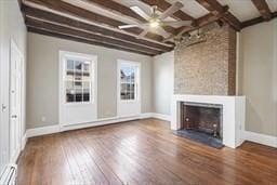 unfurnished living room featuring hardwood / wood-style flooring, a large fireplace, and beam ceiling