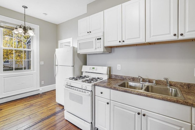 kitchen with sink, baseboard heating, pendant lighting, white appliances, and white cabinets