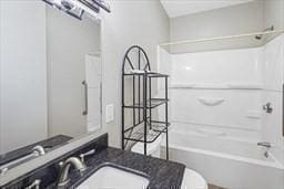 full bathroom with vanity, bathtub / shower combination, and toilet