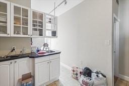 kitchen featuring sink and white cabinets