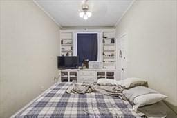 bedroom with ornamental molding