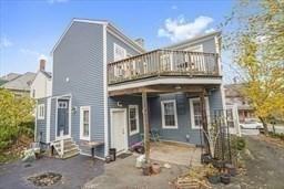 rear view of property featuring a deck and a patio